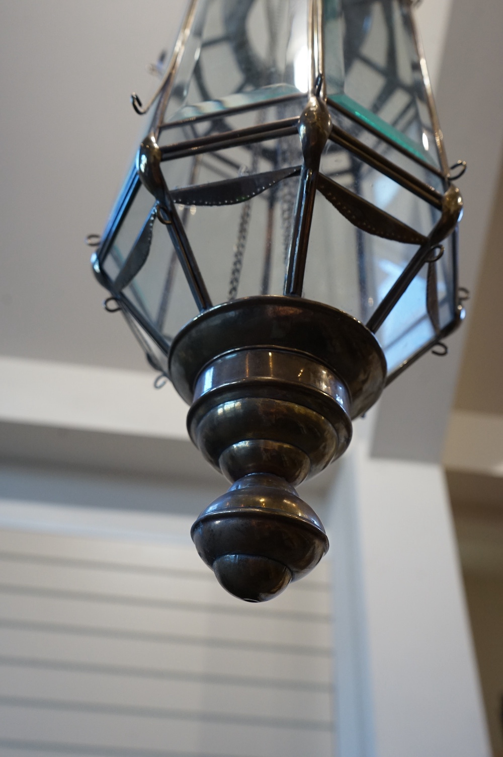 A Moroccan hanging brass and eight panelled glass lantern, 60cm long. Condition - good